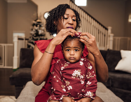Mother fixing daughters hair