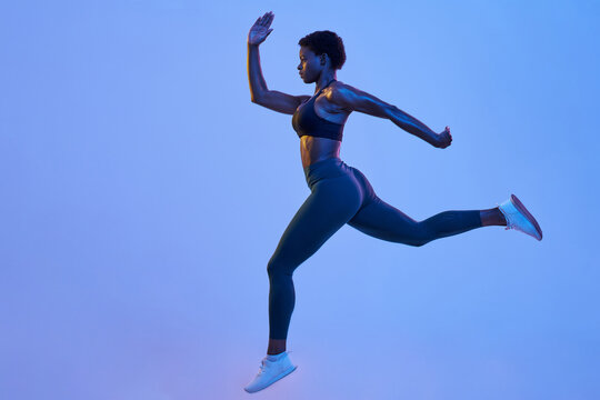 Powerful black athlete leaping during workout - Powered by Adobe