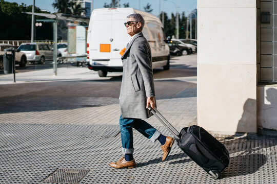 Elderly traveler walking on city street