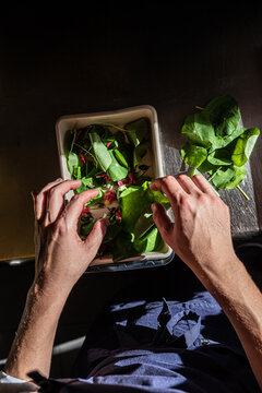 Selecting leafs and flowers in a restaurant kitchen