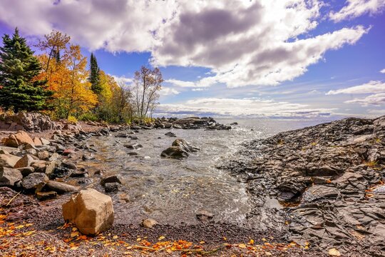Cloudy blue sunny sky over Lake Superior cove at Tettegouche State Park