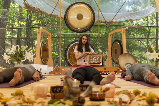 Therapist performing music therapy with a Shruti box
