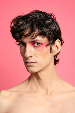 Shirtless man with bright makeup