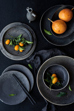 Still life with ceramics and fruits, kumquat and granadilla