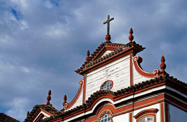Fototapeta na wymiar Baroque church cross and pinnacles, Diamantina, Brazil 