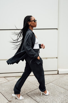 Woman in grey suit walking downtown