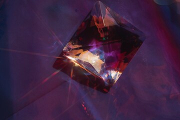 Crystal on violet background with star shaped sunbeam