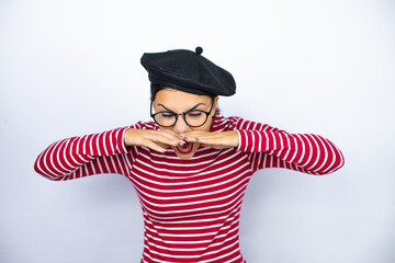 Young beautiful brunette woman wearing french beret and glasses over white background shouting and screaming loud down with hands on mouth