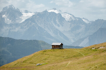 A small alpine wooden cabin on a hill in La Chaux Verbier, Switzerland