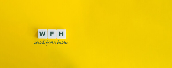 Work from home (WFH) concept with Copy Space. Block letters and curvise typography on bright yellow background. Minimal aesthetics.