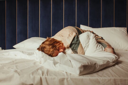 Tired woman laying on bed