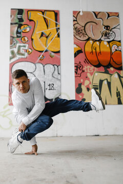 Boy dancing and making difficult tricks outdoor.