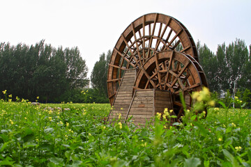 old wooden watermill in field