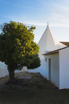 Small white chapel with a tree during sunset in south of Portugal