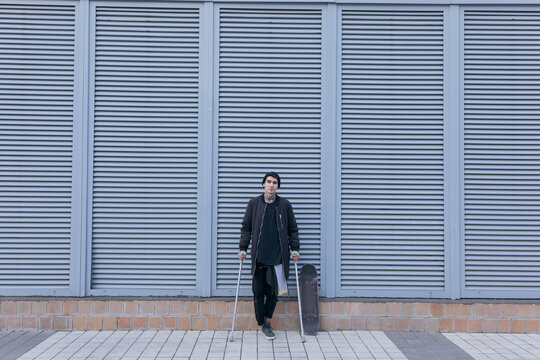 photo of a guy without a foot at grey background