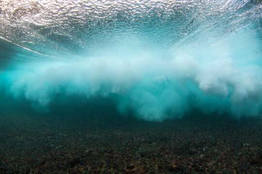 An Underwater Perspective Of A Breaking Wave Exploding Above The Surface