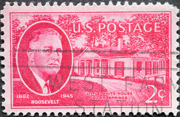 USA - Circa 1945: a postage stamp printed in the US showing a portrait by Franklin Roosevelt Stamps. Background: Little White House in Warm Springs, Georgia