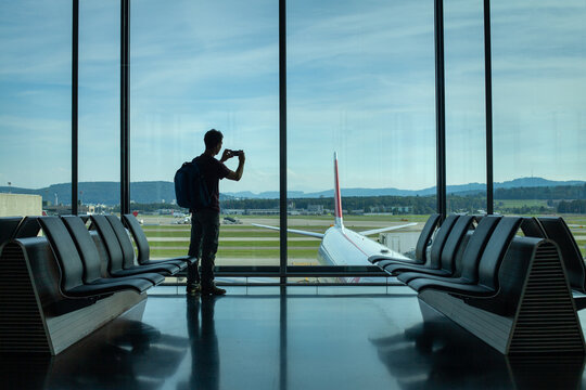 traveler in airport, silhouette of backpacker waiting for the flight, people traveling
