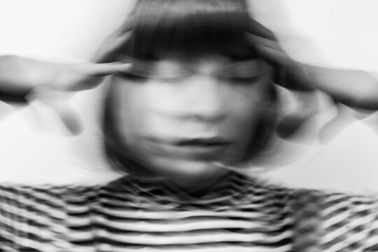 headache, portrait of stressed woman, motion blur