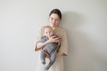 stock photo of mom and baby on a pastel background
