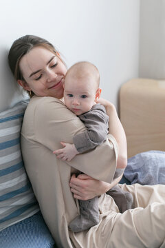 Mom Holds In Her Arms Hugs Her Baby