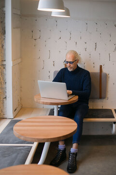 elderly business man architect doing work at a laptop