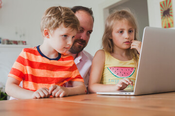 home schooling, father teaching children to use computer, home education