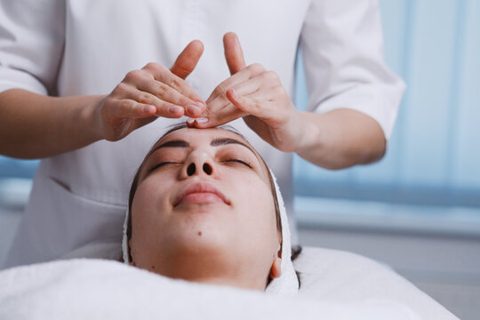 Doctor massaging by hands patient skin.