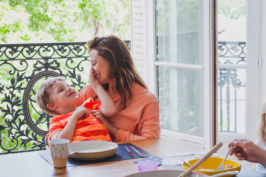 mother playing with son after eating dinner