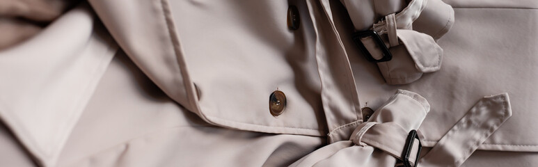 close up of stylish and beige trench coat, banner