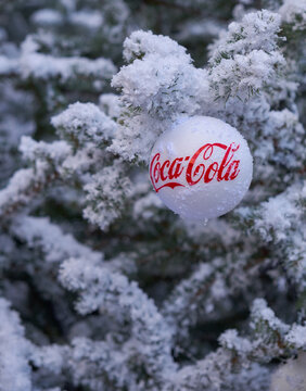 Zagreb, Croatia, December 2. 2018: Coco Cola Branded Christmas Ball Ornament In Tree Covered In Snow