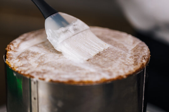 Greasing cake by brush