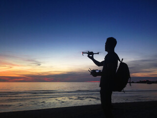 man catching drone by hand or releasing to start flight (mobile photo)