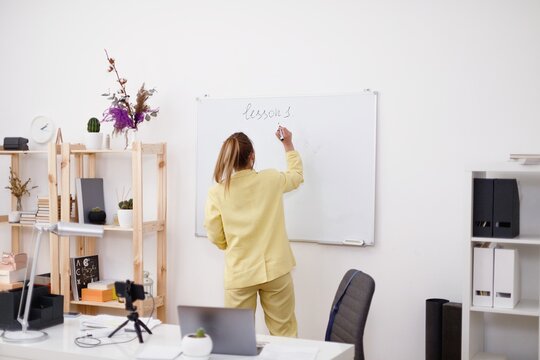 Educator checking homework with class