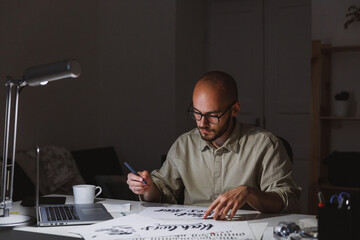 Boy painting postcards with motivational sentences