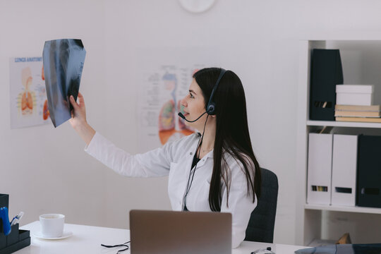 Female doctor checking x ray photo of lungs