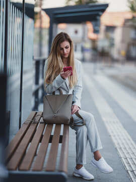 Girl sitting on empty bus stop