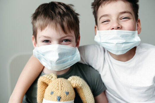 Young brothers in protective medical masks.