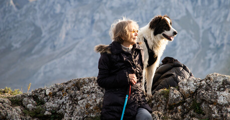 senior woman on mountain  dog social distancing