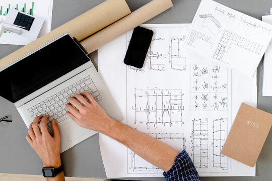 Architect working while sitting by desk at office