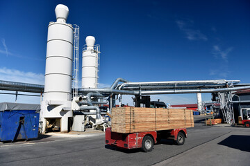 Forklift transporting planks in modern lumberyard