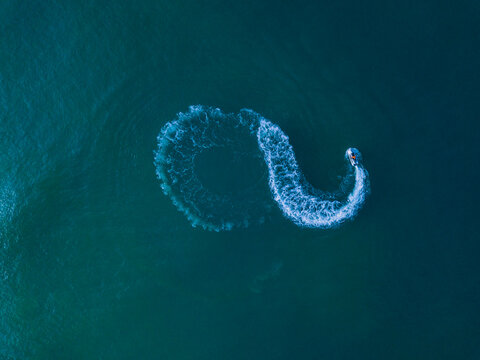 Aerial view of jet boat sailing in turquoise water