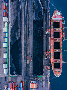 Russia, Primorsky Krai, Vladivostok, Aerial view of industrial ship moored in coal loading dock