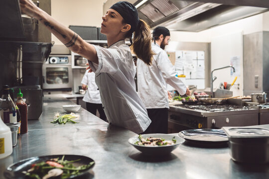 Female chef working in commercial kitchen