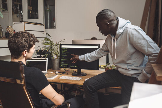 Computer programmers working on coding at workplace
