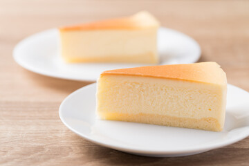 Sliced of vanilla cheesecake on white plate