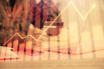 Multi exposure of woman on-line shopping holding a credit card and financial graph drawing. Stock...