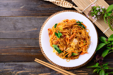 Asian food, vegetarian stir fried noodles with mushroom and vegetables, Top view