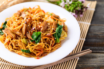 Asian food, vegetarian stir fried noodles with mushroom and vegetables