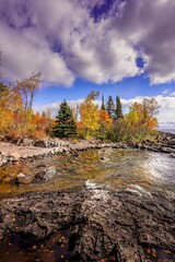 Colorful trees along a cove on a rocky beach on Lake Superior at Tettegouche State Park 